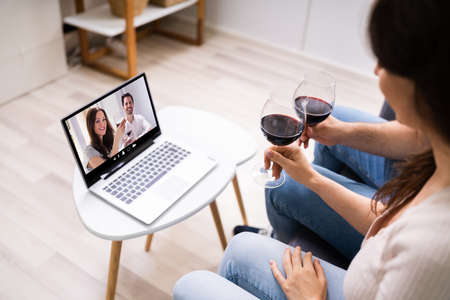 Virtual Wine Tasting Using Laptop. Online Party And Drinksの写真素材