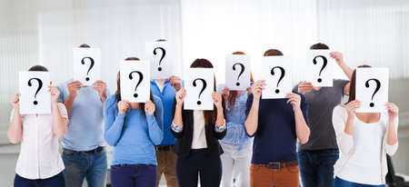 Confused Student Group Holding Mystery Question Signsの写真素材