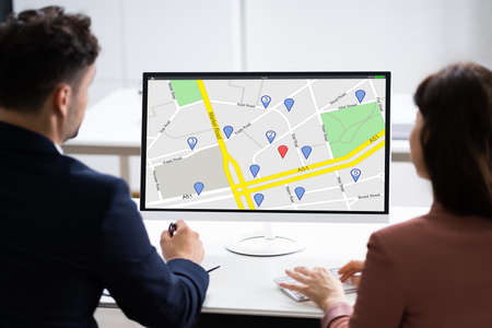 Business People Looking At Online GPS Navigator Location Map