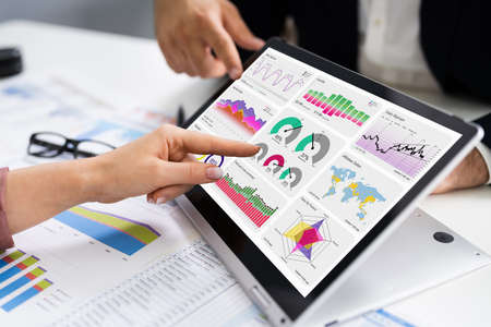 Financial Analyst Using Convertible Laptop Screen With Graphsの写真素材