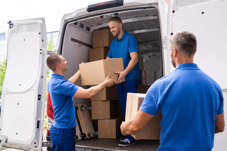 Truck Movers Loading Van Carrying Boxes And Moving House