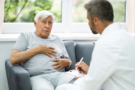 Home Care Elder Patient Talking To His Doctor