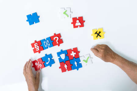Elder Man Playing Jigsaw Puzzle On Table