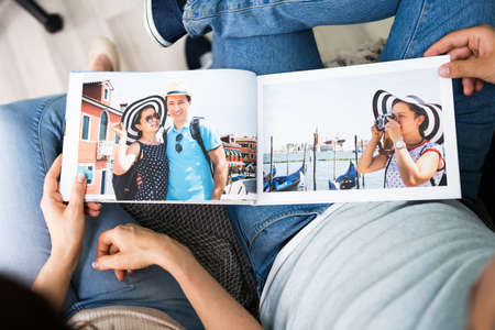 Couple Family Looking Photo Album Or Photobook