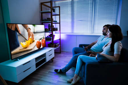 Family Watching TV Through Tablet Television And Movie Streaming