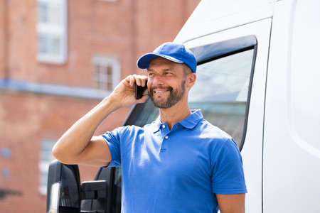 Handyman Men Talking On Mobile Phone Near Truck Or Van