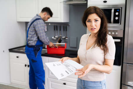 Customer Woman With Expensive Repairs Invoice At Home
