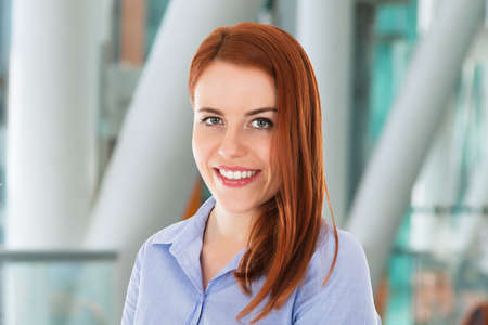 Smiling Young Woman Portrait At Workplace In Office