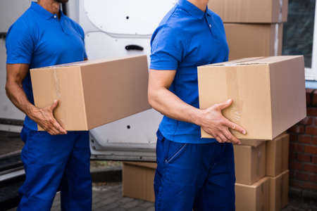 Truck Movers Loading Van Carrying Boxes And Moving Houseの写真素材