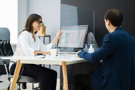 Financial Advisor Meeting With Client Customer Protected Using Sneeeze Guard