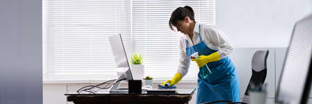 Janitor Cleaning Office Desk. Hygiene Cleaner Serviceの写真素材
