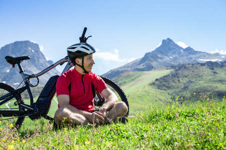 E Bike Bicycle In Austria. Man In Helmet With Mountain Ebikeの写真素材