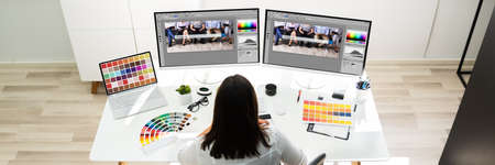 Graphic Designer Artist Working On Multiple Computer Screens