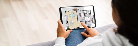 Buying House Online On Tablet Computer. Home Management