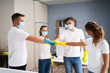 Professional Office Cleaning Janitor Team Spirit And Huddle With Face Masksの写真素材