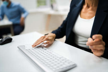 Cleaning Computer Keyboard Using Sanitizer Alcohol Wipeの写真素材