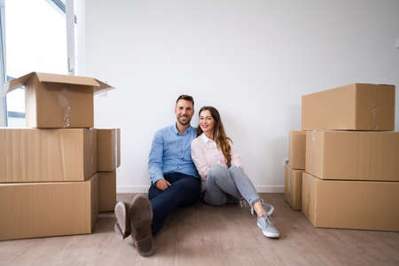 Happy Young Couple Moving Into New House
