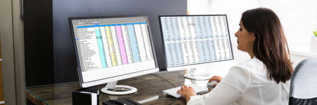 Analyst Working With Spreadsheet Business Data On Computer
