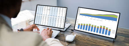 Analyst Working With Spreadsheet Data On Computer