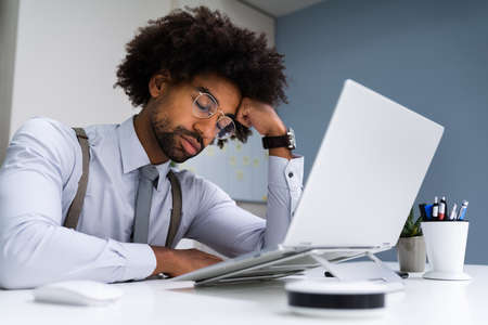 Restful Unhappy African Man Sleeping At Workの写真素材