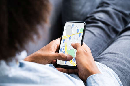African American Using Navigation Map On Mobile Phone