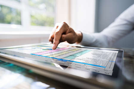 African American Using Business Spreadsheet On Tablet