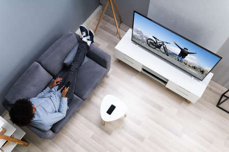 African American Streaming And Watching Movie On TV Screen