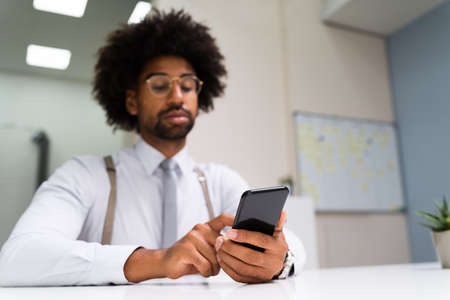 African Man Holding Smartphone Or Mobile Phone