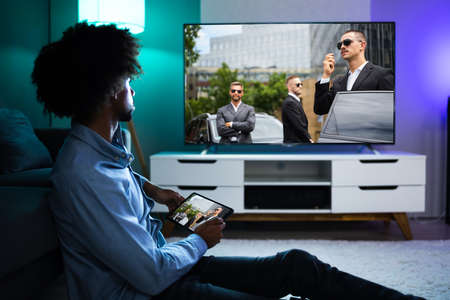 African American Streaming And Watching Movie On TV Screen