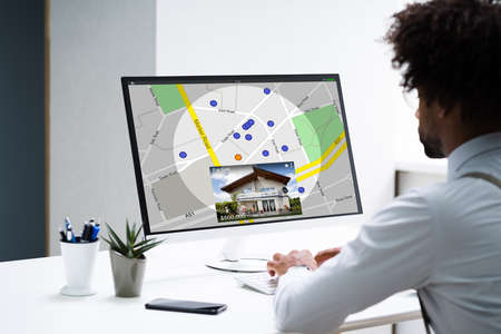 African American Searching Real Estate House On Map