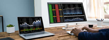 African American Analyst Trading ON Stock Exchange Using Laptop Computer