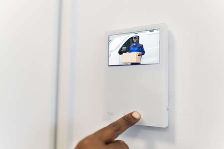 African Man Using Video Intercom Entrance Safety System
