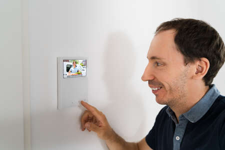 Man Using Video Intercom Entrance Safety System