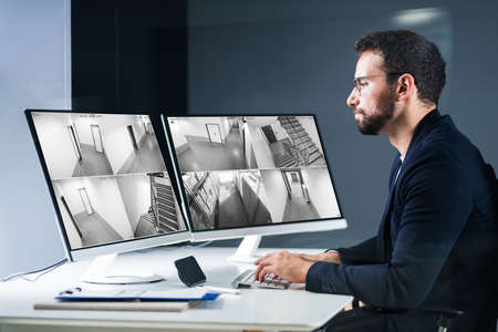 Security System CCTV Camera Operator Using Computer Monitor