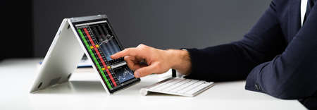 Stock Exchange Business Analyst Using Convertible Laptop Computer