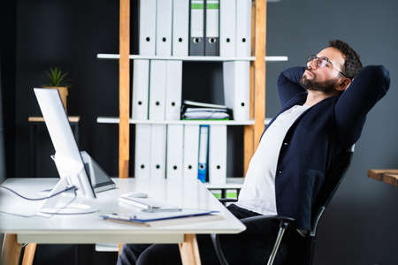 Relax And Lean Back In Office Computer Chairの写真素材