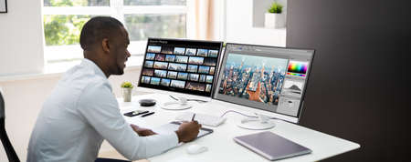 African Graphic Web Designer Using Design Editing Software