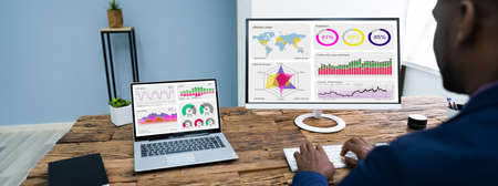 African American Analyst Using Financial Business Data On Computer