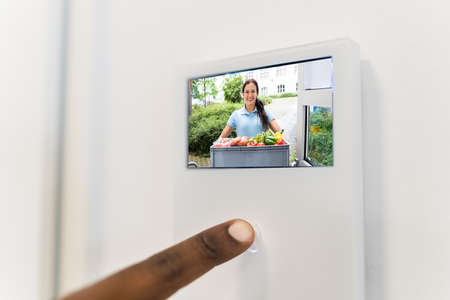 African Man Using Video Intercom Entrance Safety System