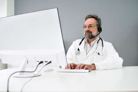 Senior Older Man Doctor Computer Video Conferenceの写真素材