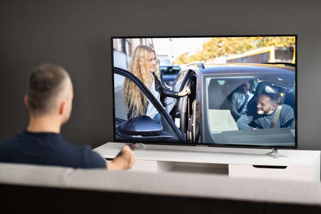 Man Streaming And Watching Movie On TV Screenの写真素材