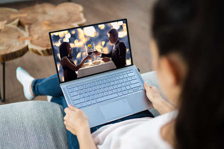 Watching TV Video On Laptop At Sofa Or Couch