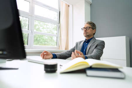 Healthy Yoga Meditation Exercise In Office Chair At Workplaceの写真素材