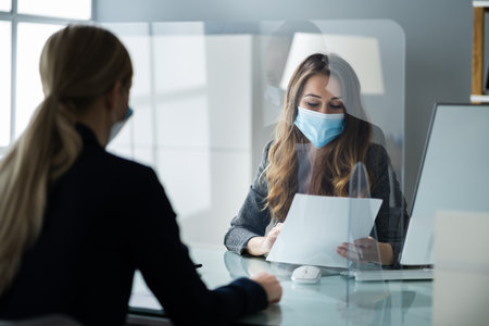 Financial Advisor Or Tax Consultant Wearing Medical Face Maskの写真素材