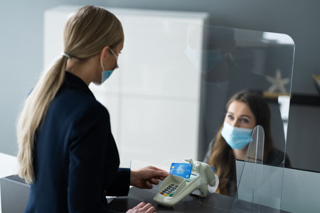 Hotel Reception Desk Counter With Face Maskの写真素材