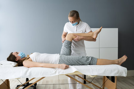 Knee Injury Rehab Massage And Physiotherapy In Face Maskの写真素材