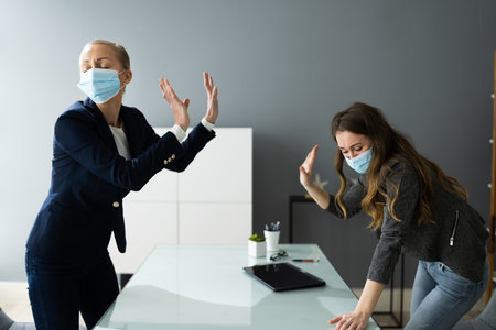 Angry Women Fighting And Shouting At Work With Face Masksの写真素材