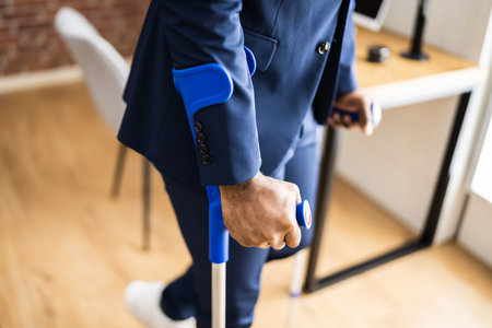 African Man Using Crutches For Recovery After Leg Fractureの写真素材