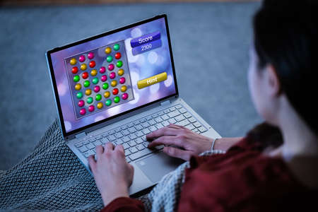 Woman Playing Online Video Game On Laptopの写真素材