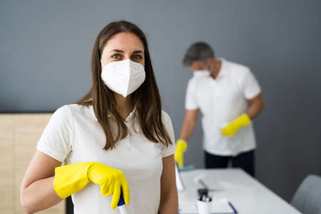 Cleaning Service Janitor Near Desk In Covid Face Mask